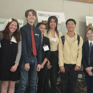 Group of young people smiling at an event.