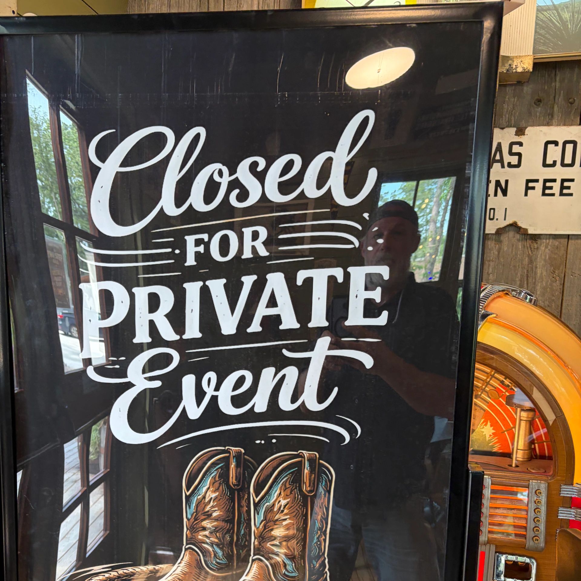 Sign stating "Closed for Private Event" with cowboy boots illustration.