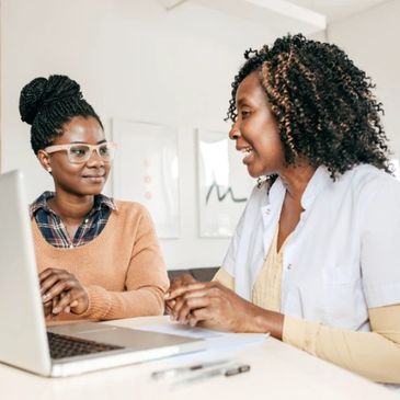 Women talking at a desk