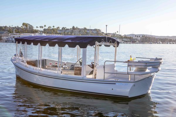 White leisure boat on water with canopy.