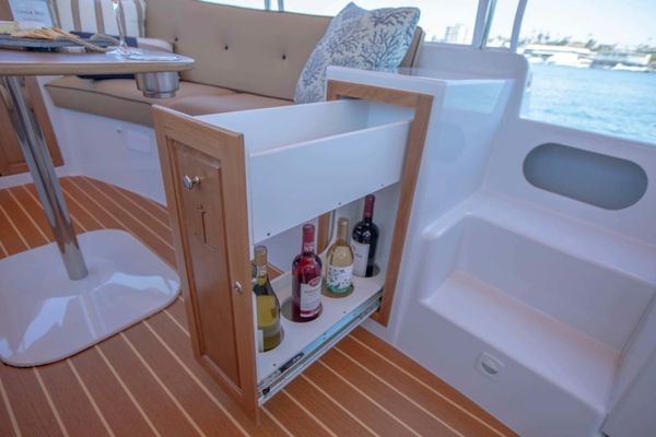 Pull-out wine storage cabinet on a boat deck.