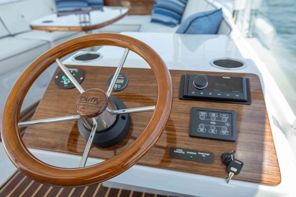 Steering wheel and control panel on a boat.