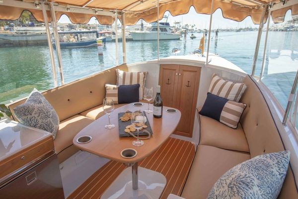 Cozy boat seating area with snacks and wine.