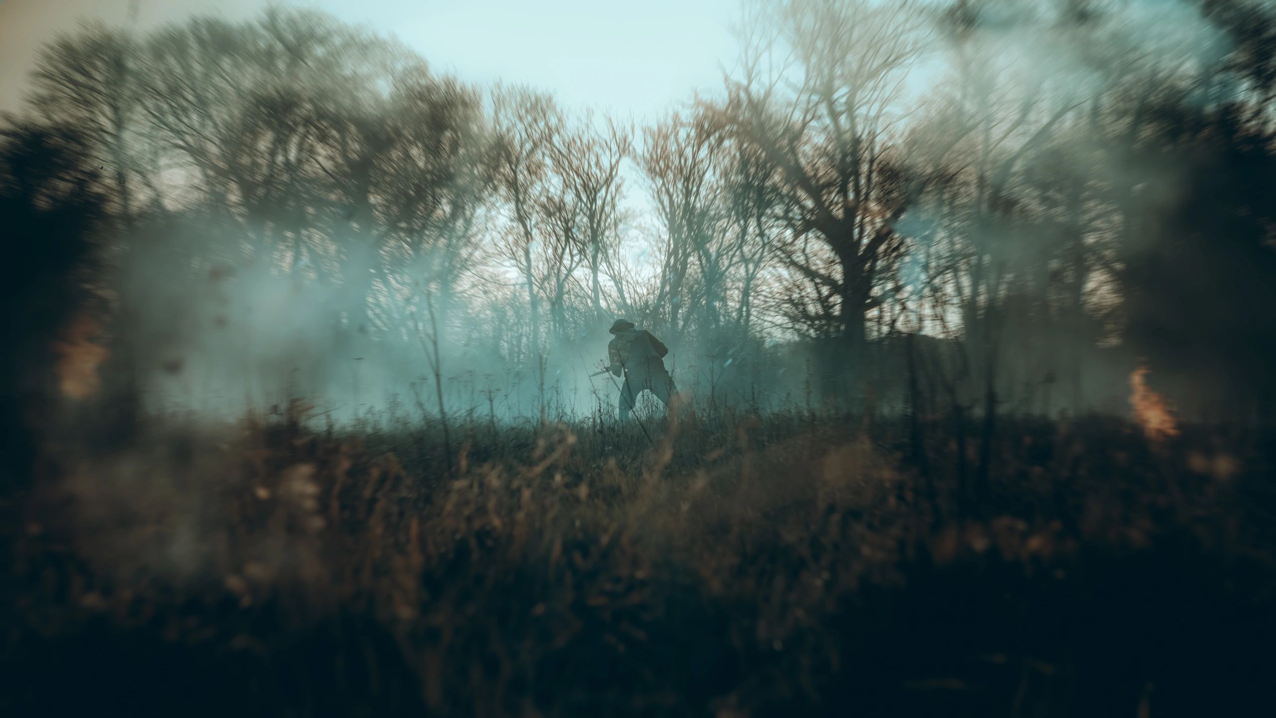 Solitary soldier in a smoky battlefield.