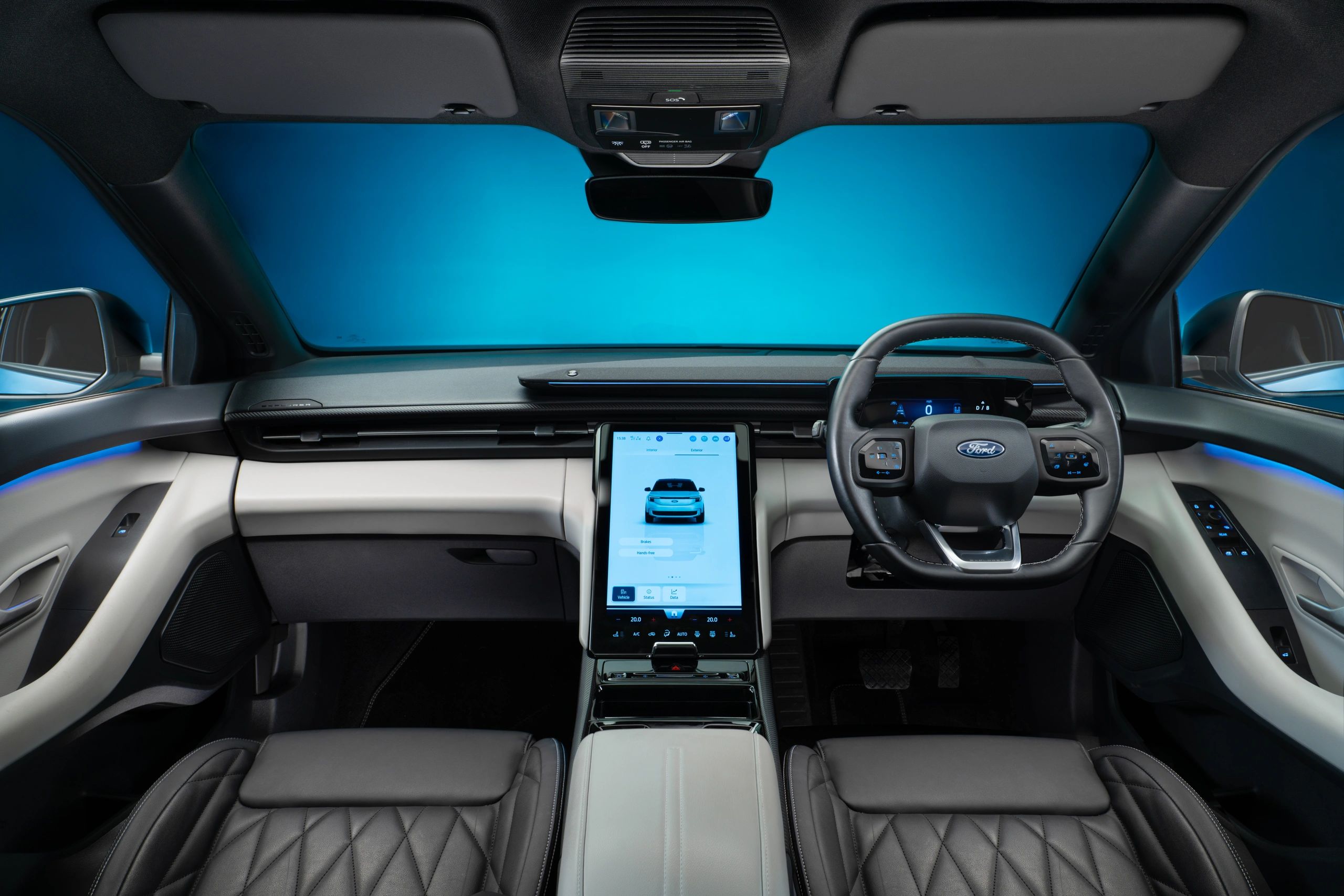 Modern Ford car interior with digital displays and luxury seats.