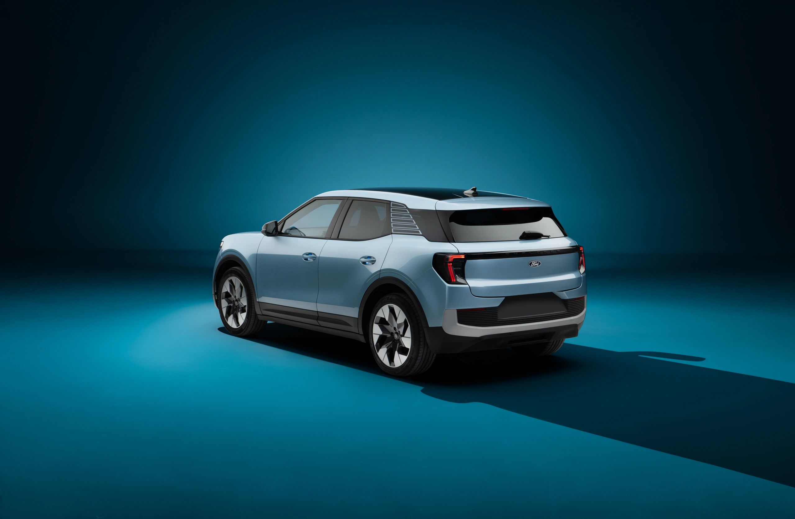Modern electric SUV in blue on a teal background.