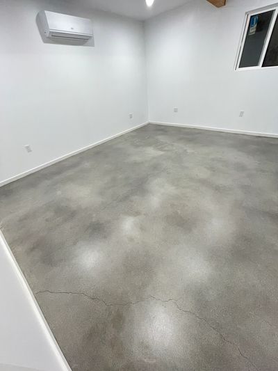 New construction with bare walls and stained and sealed concrete flooring.