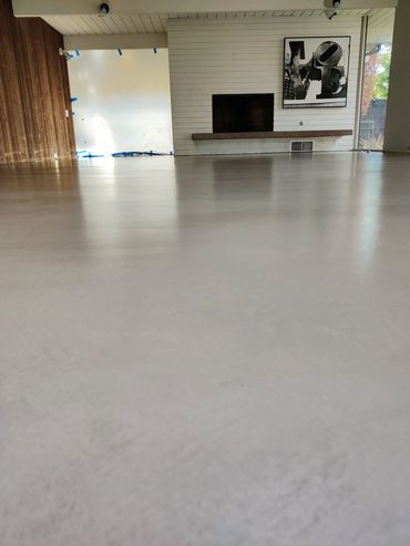 Low-angle view of a modern room with a fireplace and LOVE artwork.
