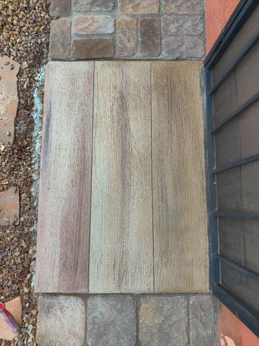 Stone and gravel pathway with a metal gate on the right.