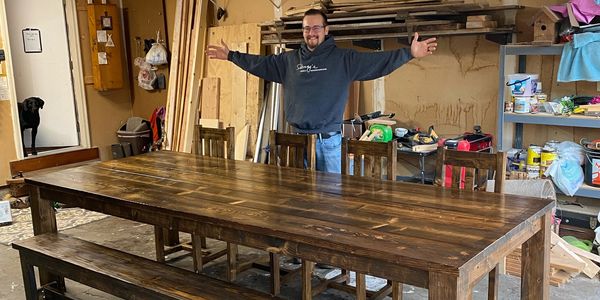 Custom 10 foot long brown table with bench and 4 chairs.