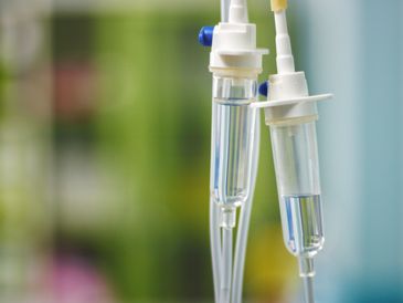 Close-up of IV drip chambers with fluid.