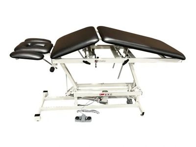 Adjustable treatment or massage table with black cushions.