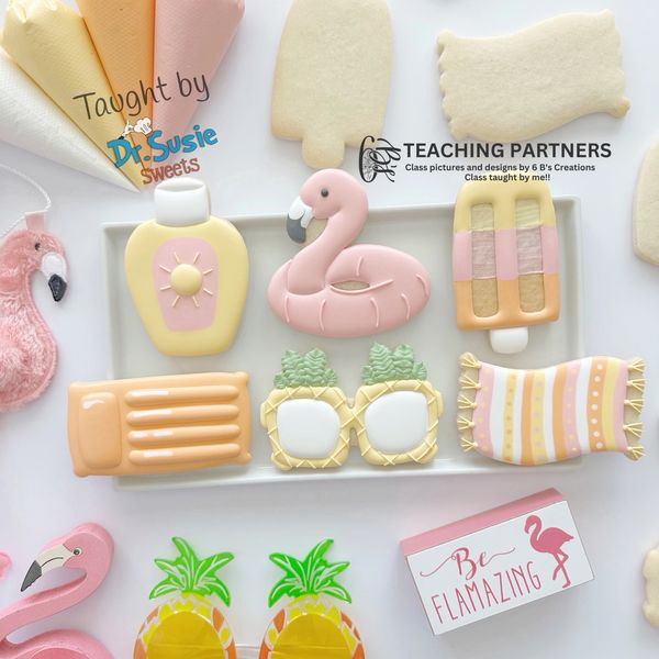 Colorful summer-themed decorated cookies with flamingo and pineapple designs.
