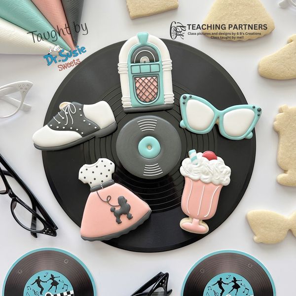 50s themed decorated cookies on a vinyl record display.