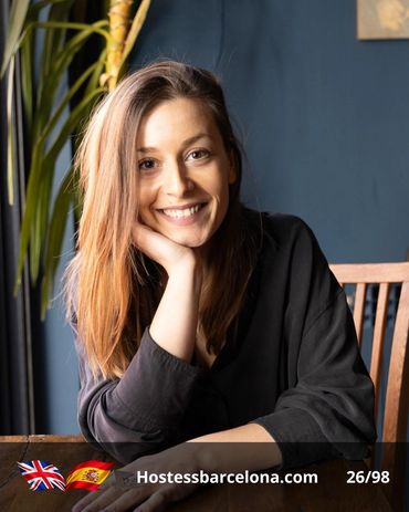Multilingual event hostess assisting international attendees and exhibitors.