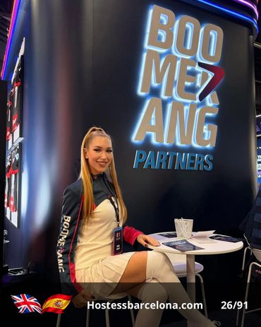 Multilingual hostess welcoming clients at an international exhibition.