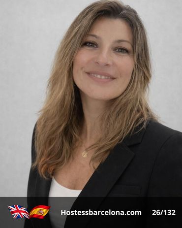 Professional hostess welcoming VIP guests at a trade show stand.