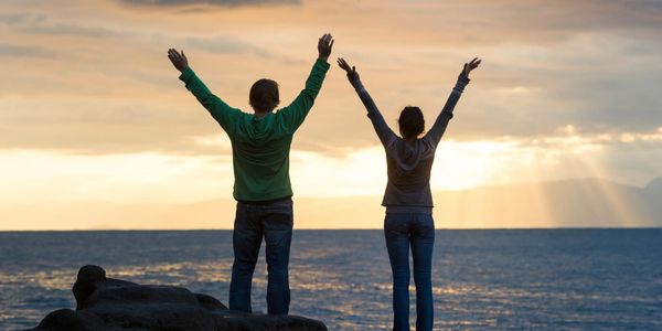 Two people arms outstretched