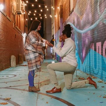 Photo of Aiko proposing to her wife, Carolann.