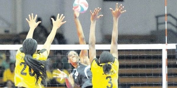 Photo of Aiko blocking a ball while representing the Jamaican Senior National Volleyball Team.