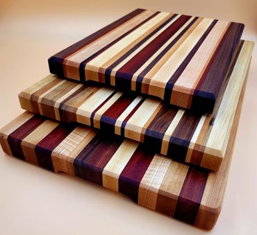 Stack of three unique cutting boards in different sizes