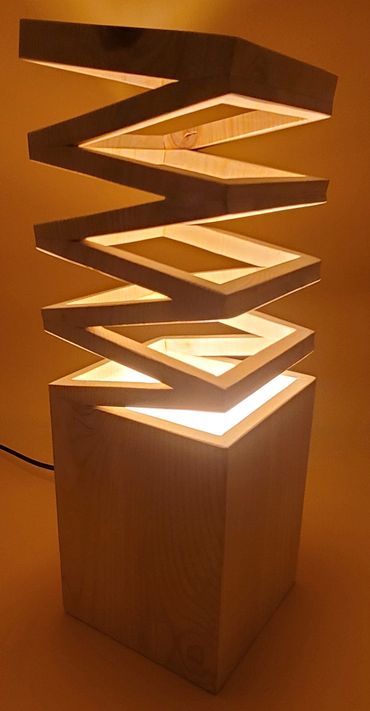 Slinky top wooden light sculpture.