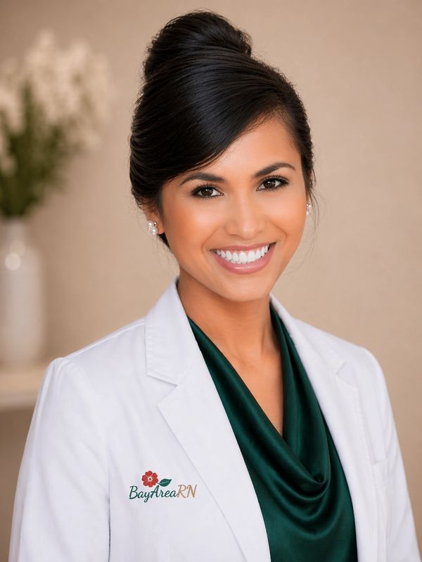 Smiling nurse in a white coat with Bay Area RN logo.