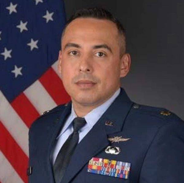 Portrait of a male military officer in uniform with U.S. flag background.
