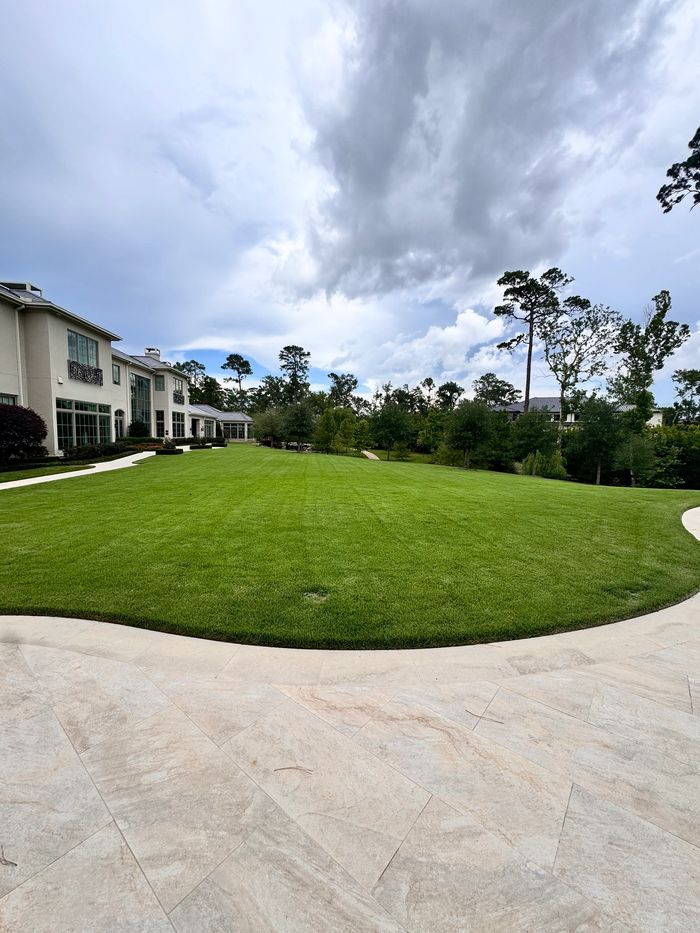 Two workers walking between solar panels at sunset.