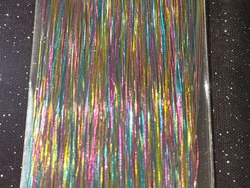 Colorful shiny strands arranged in parallel lines.