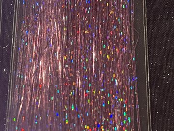 Close-up of shiny, iridescent strands with colorful sparkles.