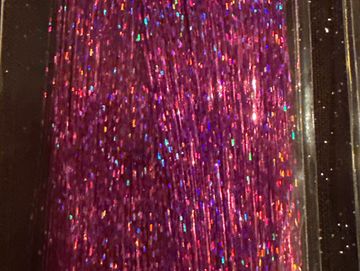 Close-up of shimmering purple glitter with multicolored sparkles.
