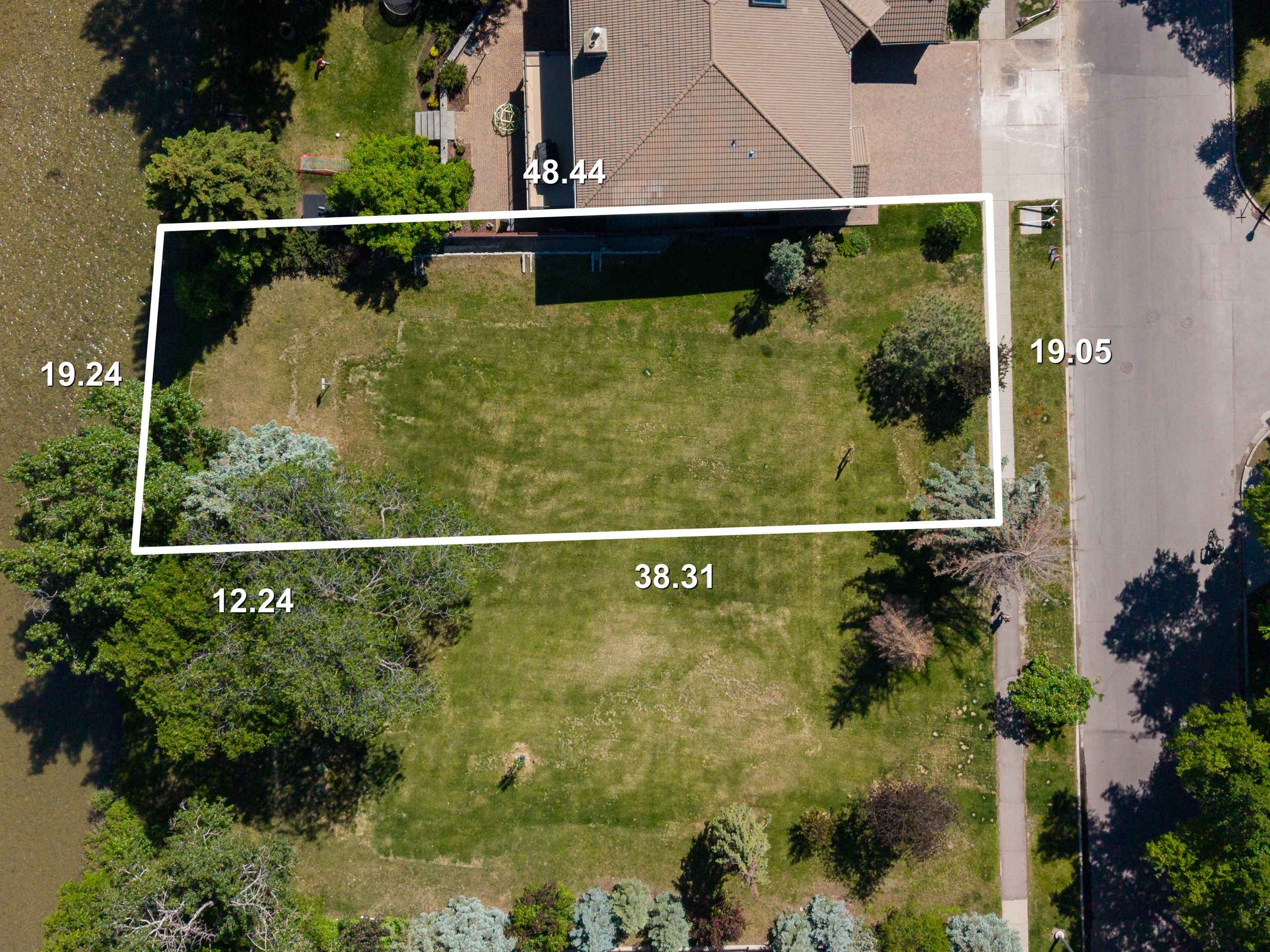 Aerial view of a property with boundary lines and measurements marked.