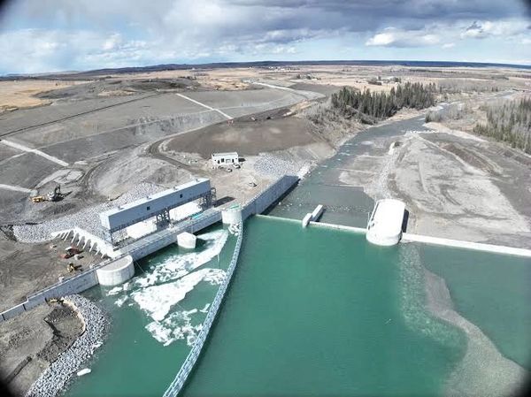 Aerial view of a dam controlling water flow in a rural area.