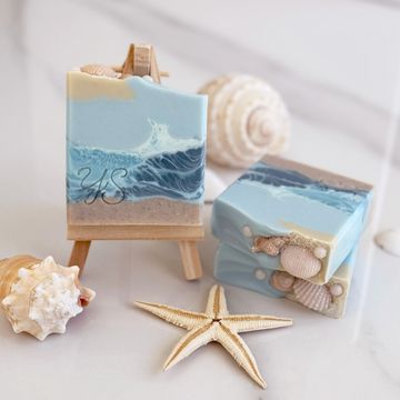 Soaps with various blue shades representing the sea and waves, and a beige layer resembling sand. 