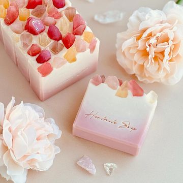 Elegant handcrafted soaps with pastel pink-to-white gradients and crystal-like embeds on top. 