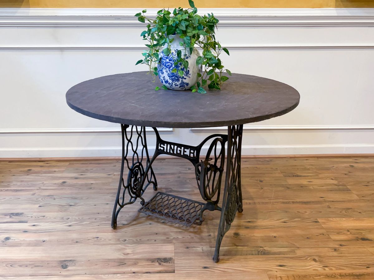 Antique Outdoor Patio Dining Table with Cast Iron Singer Sewing Machine  Base and Round Gray Slate Top.