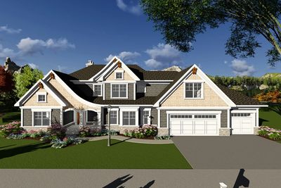 Large modern suburban house with a three-car garage and landscaped yard.