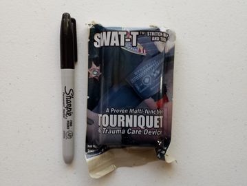 Close up of a Sharpie placed parallel to a SWAT-T Tourniquet.