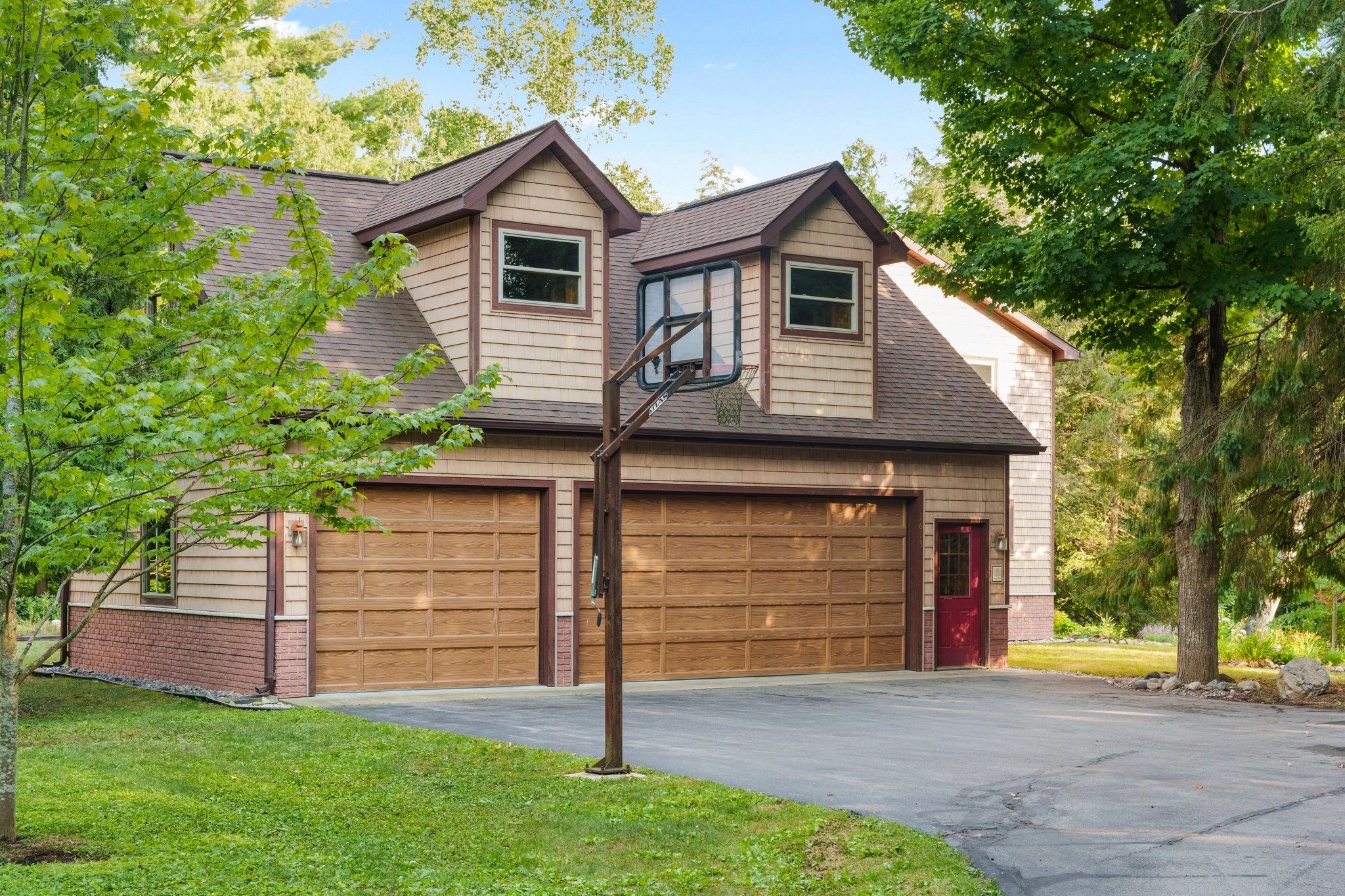 A house with a basketball hoop in the driveway