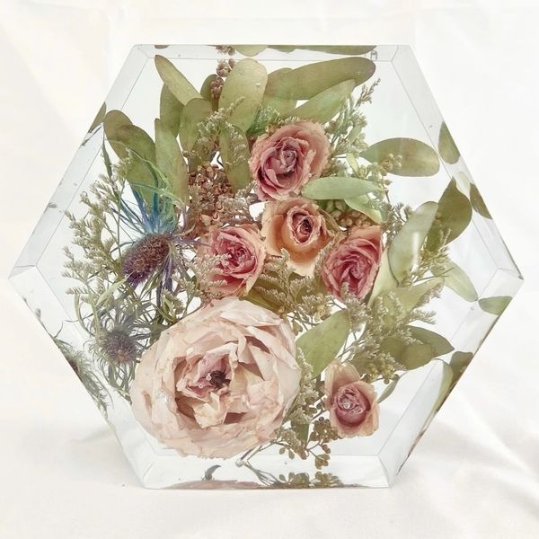 Preserved bridal bouquet flowers in resin hexagon. 