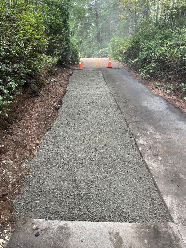 Long driveway needs patch after tree roots and  cracked asphalt removed in Port Orchard, WA.