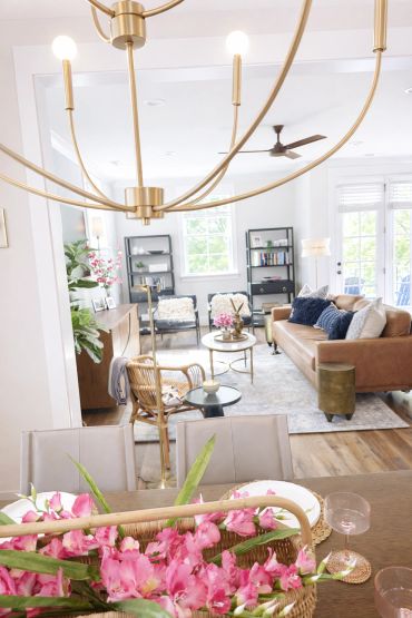 Bright, modern living room with neutral tones and floral accents.