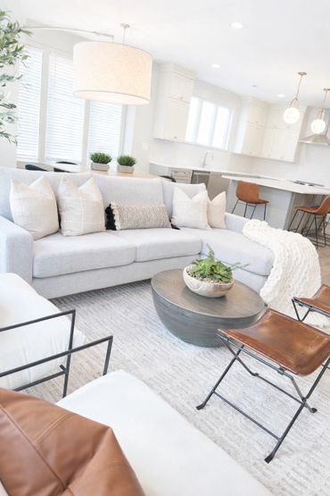 Bright modern living room with cozy seating and neutral tones.
