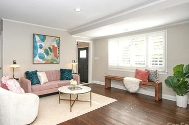 Artwork including two framed abstract paintings on the walls, adding visual interest.