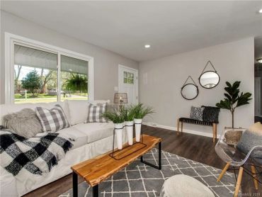 Cozy living room with neutral tones and rustic wooden accents.