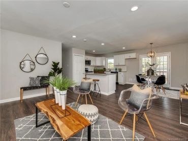 Modern open-plan living area with kitchen and dining space.