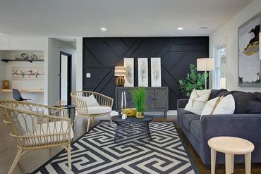 Geometric patterned rug adding visual interest and defining the seating area.