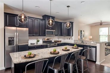 Pendant lights adding a touch of elegance and providing focused lighting for the kitchen island.
