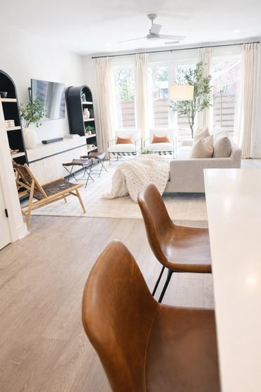 Bright and modern living room with neutral tones and leather chairs.